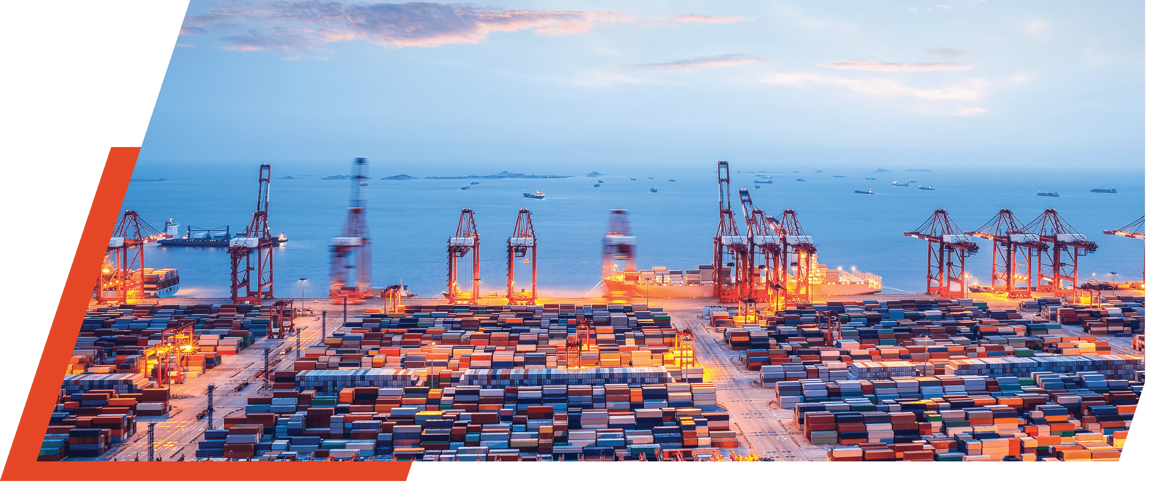 Container port with cranes and containers at dusk